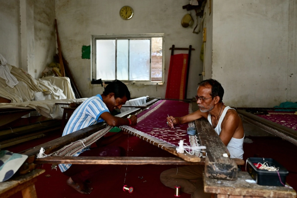 Rathwa-dorpsbewoner brengt ceremoniële gezichtsverf aan voorafgaand aan een spirituele dans in India.